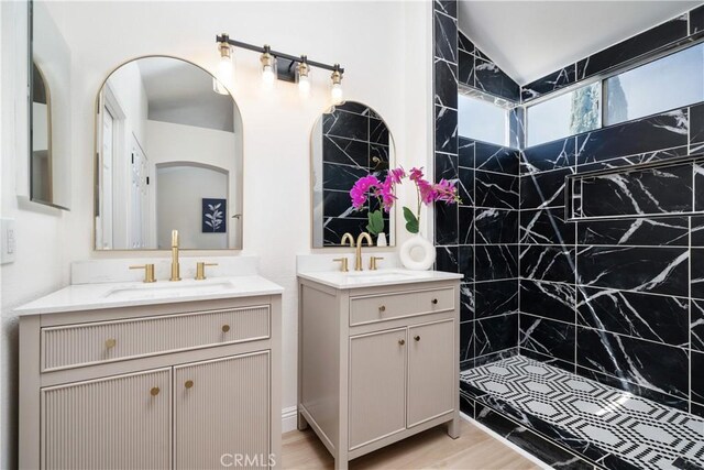 23760 Timber Bluff Ct, Moreno Valley, CA 92557 - full bath with two vanities, tiled shower, wood finished floors, and lofted ceiling