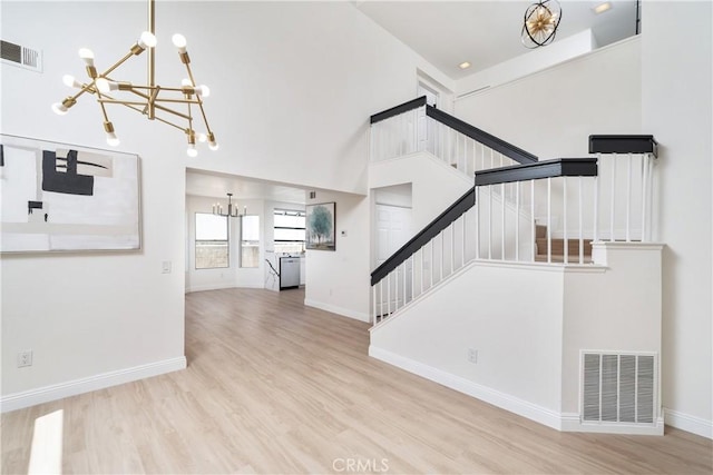 23760 Timber Bluff Ct, Moreno Valley, CA 92557 - unfurnished living room featuring a chandelier, stairway, and wood finished floors