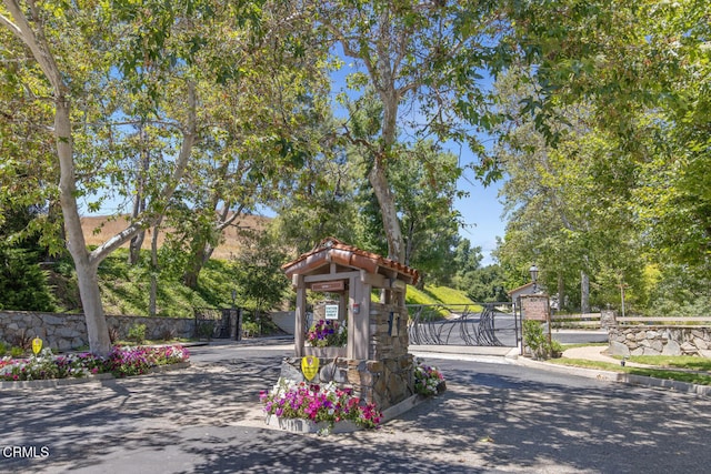 4062 Bridgewood Ln, Thousand Oaks, CA 91362 - view of asphalt road featuring a gate, curbs, and a gated entry