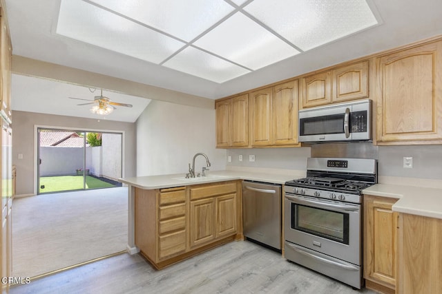 4062 Bridgewood Ln, Thousand Oaks, CA 91362 - kitchen with stainless steel appliances, a peninsula, light wood finished floors, light countertops, and ceiling fan