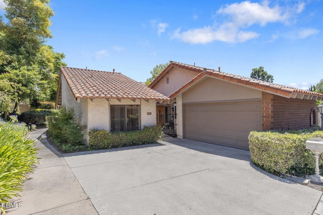 4062 Bridgewood Ln, Thousand Oaks, CA 91362 - mediterranean / spanish-style home featuring a tiled roof, an attached garage, stucco siding, and concrete driveway