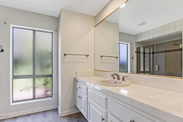 4062 Bridgewood Ln, Thousand Oaks, CA 91362 - bathroom with healthy amount of natural light, vanity, a stall shower, and wood finished floors