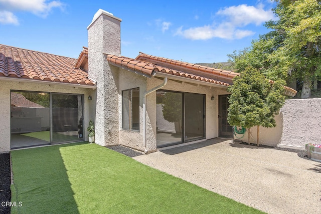4062 Bridgewood Ln, Thousand Oaks, CA 91362 - back of house with a tiled roof, stucco siding, a patio, and a chimney