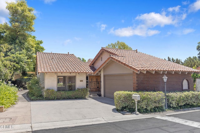 4062 Bridgewood Ln, Thousand Oaks, CA 91362 - view of front of house featuring a tile roof, an attached garage, stucco siding, and driveway