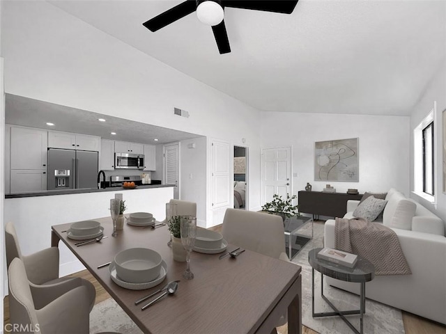 17333 Brookhurst St Unit D6, Fountain Valley, CA 92708 - dining room with a ceiling fan, light wood-style floors, and high vaulted ceiling