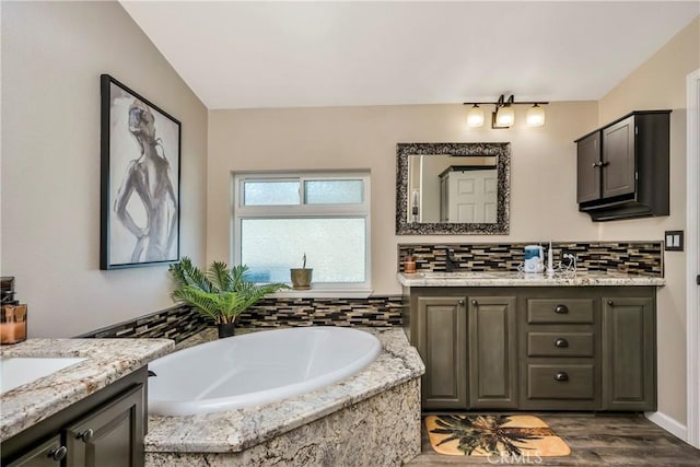 17432 Sendero Way, Lower Lake, CA 95457 - bathroom featuring vanity, a bath, tasteful backsplash, and wood finished floors