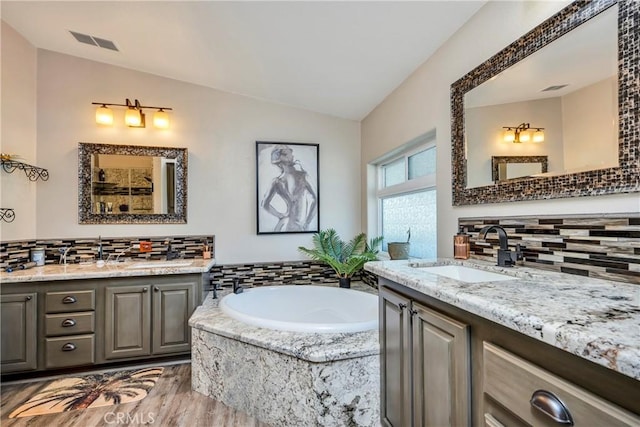 17432 Sendero Way, Lower Lake, CA 95457 - bathroom with lofted ceiling, decorative backsplash, two vanities, and a garden tub