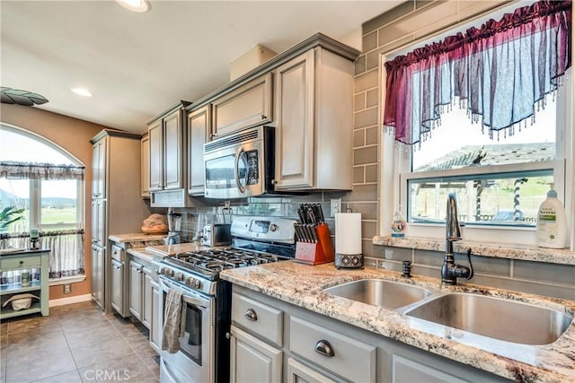 17432 Sendero Way, Lower Lake, CA 95457 - kitchen featuring stainless steel appliances, light tile patterned flooring, tasteful backsplash, light stone counters, and gray cabinetry