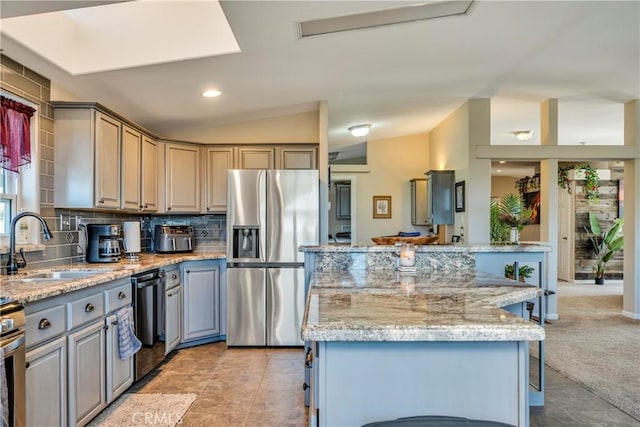 17432 Sendero Way, Lower Lake, CA 95457 - kitchen featuring stainless steel fridge, dishwashing machine, a kitchen island, decorative backsplash, and vaulted ceiling