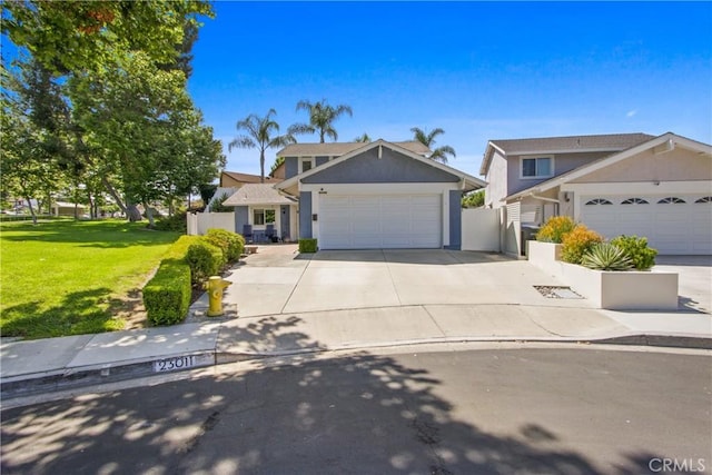 23011 Aspan St, Lake Forest, CA 92630 - traditional home featuring an attached garage, concrete driveway, and stucco siding
