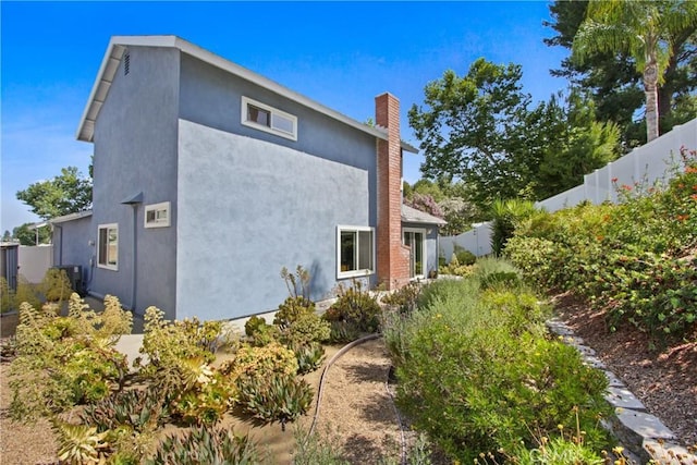 23011 Aspan St, Lake Forest, CA 92630 - view of home's exterior featuring stucco siding and a chimney