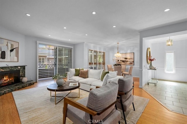 14844 Dickens St Unit 208, Sherman Oaks, CA 91403 - living room featuring light wood-style flooring, recessed lighting, a fireplace, and a chandelier