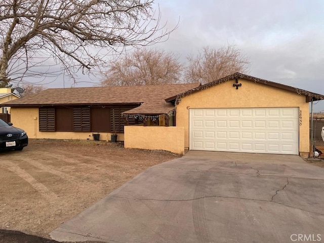 38950 164th St E, Palmdale, CA 93591 - view of front of house featuring stucco siding, concrete driveway, a garage, and roof with shingles
