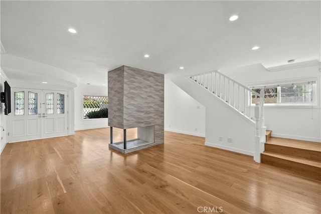 4919 Dunsmore Ave, La Crescenta, CA 91214 - unfurnished living room with stairs, healthy amount of natural light, recessed lighting, light wood-type flooring, and a fireplace