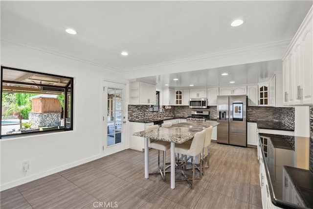 4919 Dunsmore Ave, La Crescenta, CA 91214 - kitchen with stainless steel appliances, decorative backsplash, white cabinetry, glass insert cabinets, and a kitchen island