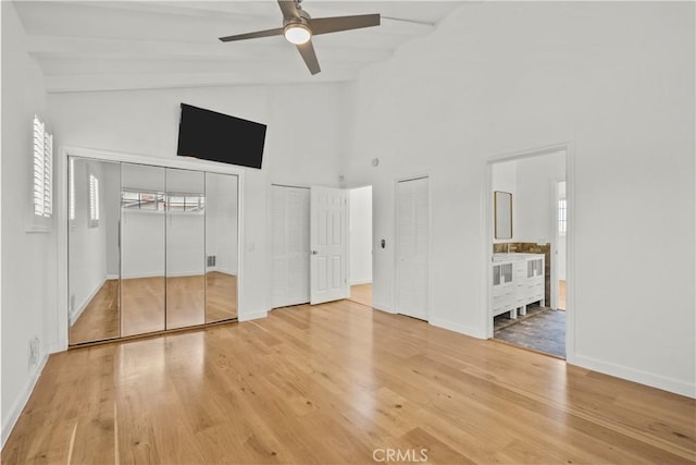 4919 Dunsmore Ave, La Crescenta, CA 91214 - unfurnished bedroom featuring two closets, light wood-style floors, high vaulted ceiling, ensuite bathroom, and ceiling fan