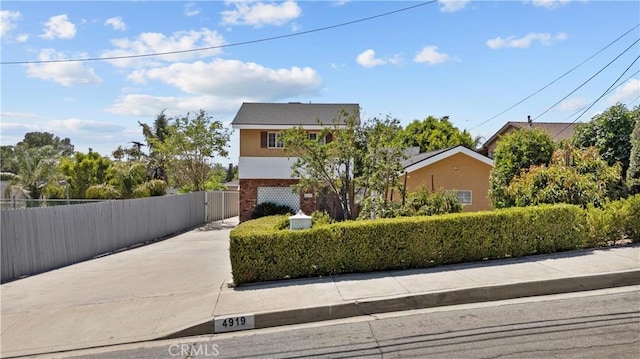 4919 Dunsmore Ave, La Crescenta, CA 91214 - view of front of home featuring driveway, brick siding, and a gate
