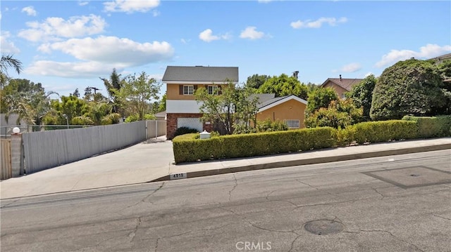 4919 Dunsmore Ave, La Crescenta, CA 91214 - view of front of home featuring concrete driveway, a garage, stucco siding, and a gate