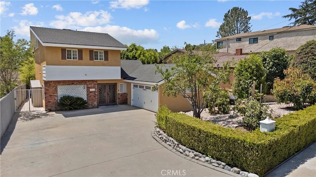 4919 Dunsmore Ave, La Crescenta, CA 91214 - view of front of property with an attached garage, concrete driveway, stucco siding, brick siding, and a gate