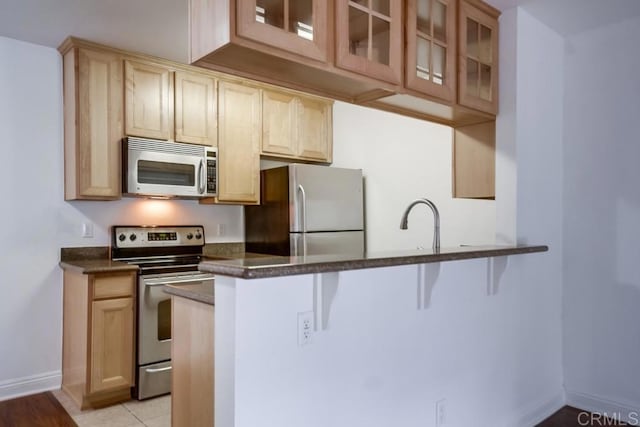 1045 Peach Ave Unit 12, El Cajon, CA 92021 - kitchen with stainless steel appliances, a kitchen bar, and glass insert cabinets