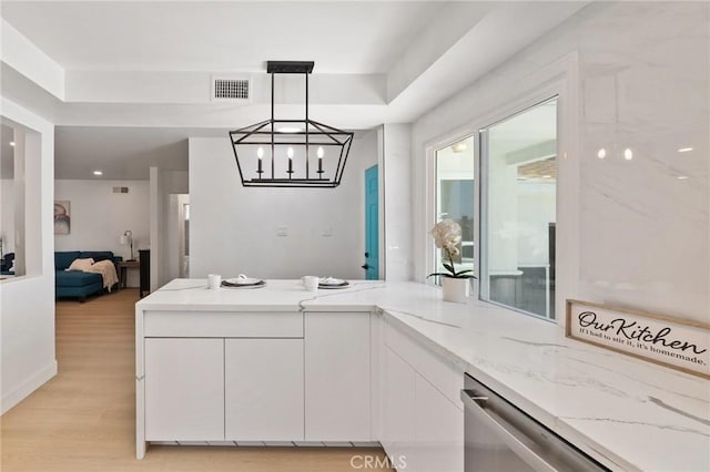 2321 W 182nd St, Torrance, CA 90504 - kitchen featuring white cabinets, light stone countertops, a peninsula, light wood finished floors, and a chandelier