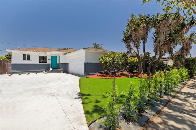 2321 W 182nd St, Torrance, CA 90504 - view of front facade featuring stucco siding, concrete driveway, a front yard, and an attached garage