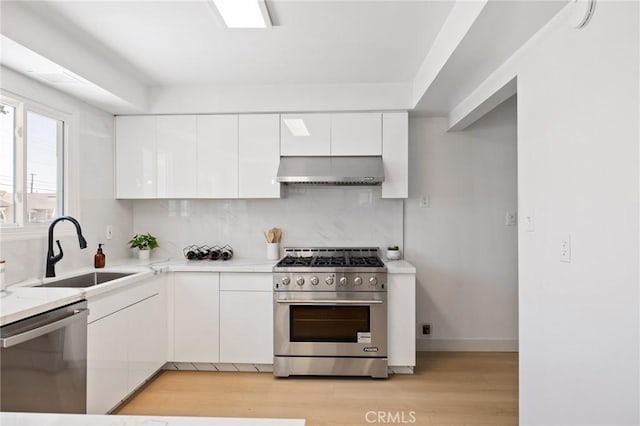 2321 W 182nd St, Torrance, CA 90504 - kitchen featuring stainless steel appliances, exhaust hood, white cabinetry, and backsplash