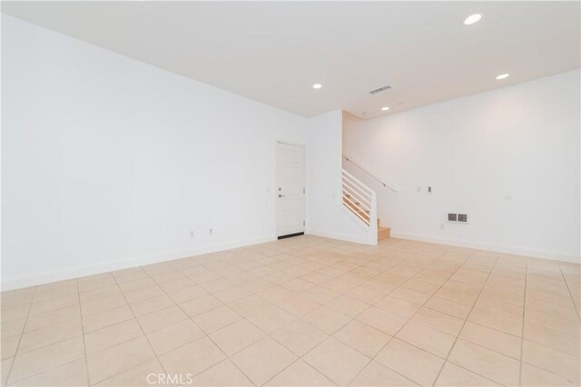 9570 Bluewater Pl, Rancho Cucamonga, CA 91730 - empty room with stairs, recessed lighting, and light tile patterned floors