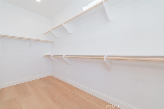 9570 Bluewater Pl, Rancho Cucamonga, CA 91730 - walk in closet featuring light wood-style flooring