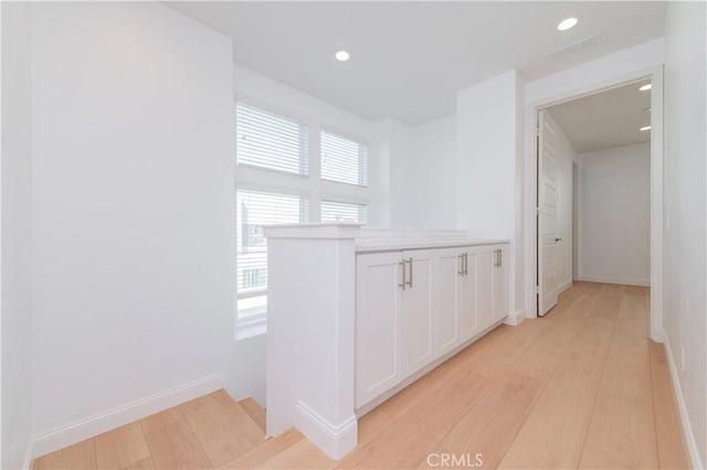9570 Bluewater Pl, Rancho Cucamonga, CA 91730 - hallway featuring light wood finished floors, recessed lighting, and an upstairs landing