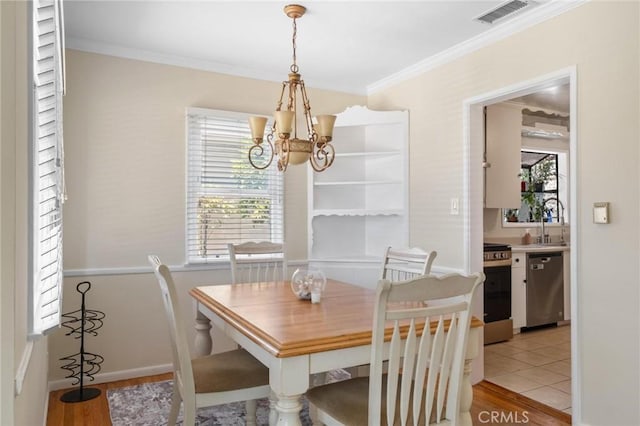 5353 W 121st St, Hawthorne, CA 90250 - dining space with a chandelier, crown molding, and light wood-style flooring
