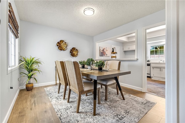 11752 Pine St, Los Alamitos, CA 90720 - dining room featuring wood-type flooring, a textured ceiling, and healthy amount of natural light