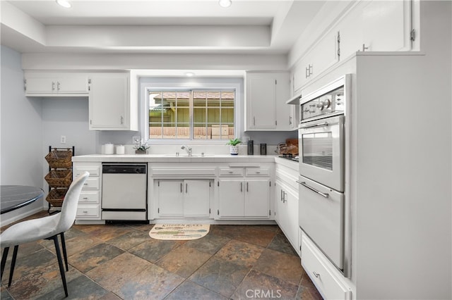 11752 Pine St, Los Alamitos, CA 90720 - kitchen featuring white appliances, tile countertops, stone tile flooring, recessed lighting, and white cabinets