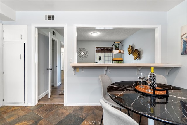 11752 Pine St, Los Alamitos, CA 90720 - dining area with baseboards and dark stone finish flooring