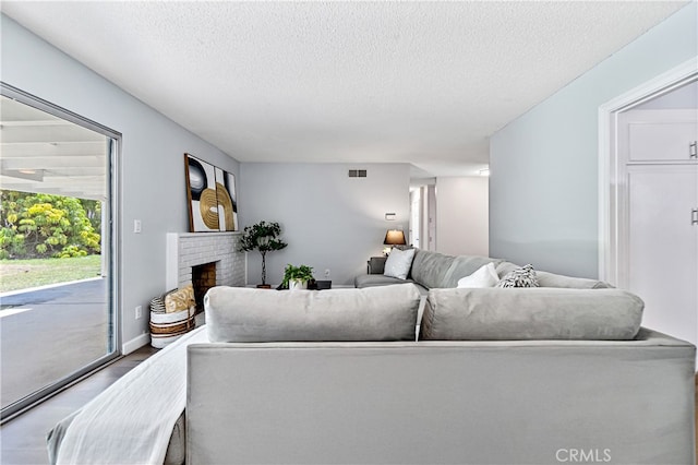 11752 Pine St, Los Alamitos, CA 90720 - living area with a textured ceiling, wood finished floors, and a fireplace