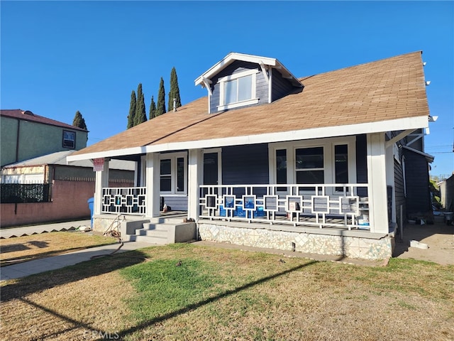 4312 Walton Ave, Los Angeles, CA 90037 - view of front of house featuring covered porch, a front yard, and roof with shingles
