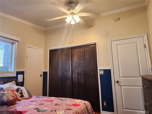 4312 Walton Ave, Los Angeles, CA 90037 - bedroom with a closet, ornamental molding, and a ceiling fan