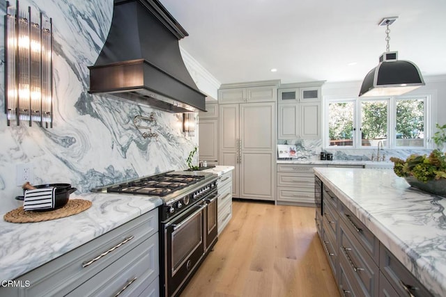 1036 S Madison Ave, Pasadena, CA 91106 - kitchen with range with two ovens, premium range hood, backsplash, light wood finished floors, and light stone counters