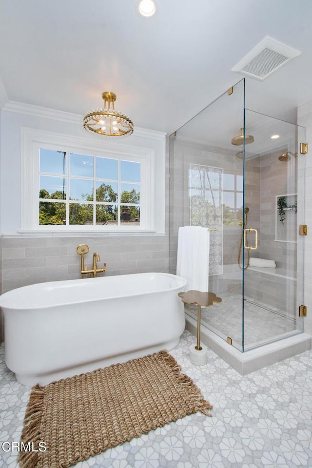 1036 S Madison Ave, Pasadena, CA 91106 - bathroom featuring tile walls, a soaking tub, a stall shower, ornamental molding, and tile patterned flooring