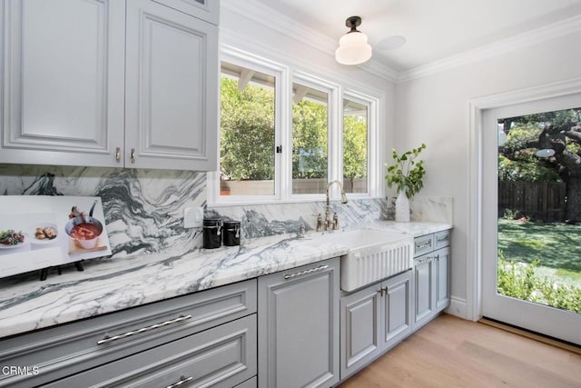 1036 S Madison Ave, Pasadena, CA 91106 - kitchen with decorative backsplash, light wood-type flooring, light stone countertops, ornamental molding, and gray cabinetry