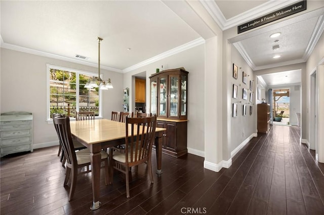 17286 Coriander Ct, Yorba Linda, CA 92886 - dining area featuring healthy amount of natural light, dark wood-style floors, a chandelier, and crown molding
