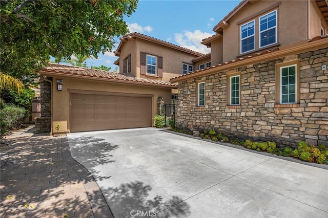 17286 Coriander Ct, Yorba Linda, CA 92886 - view of front facade with stone siding, stucco siding, driveway, and a garage
