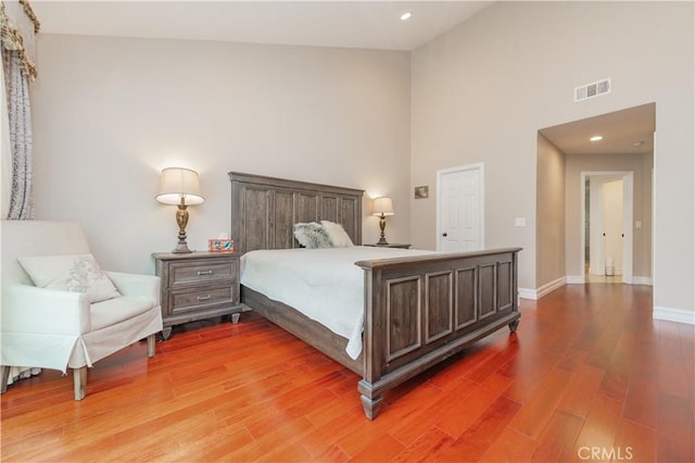 10 La Quinta Unit 21, Irvine, CA 92612 - bedroom with wood finished floors, high vaulted ceiling, and recessed lighting