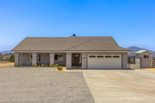 14694 Chaparral Slope Rd, Jamul, CA 91935 - single story home with a tile roof, a garage, a mountain view, and driveway
