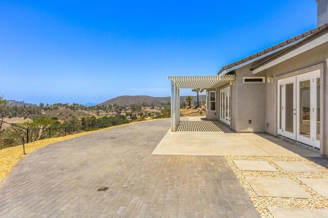14694 Chaparral Slope Rd, Jamul, CA 91935 - view of patio with a mountain view, a pergola, and french doors