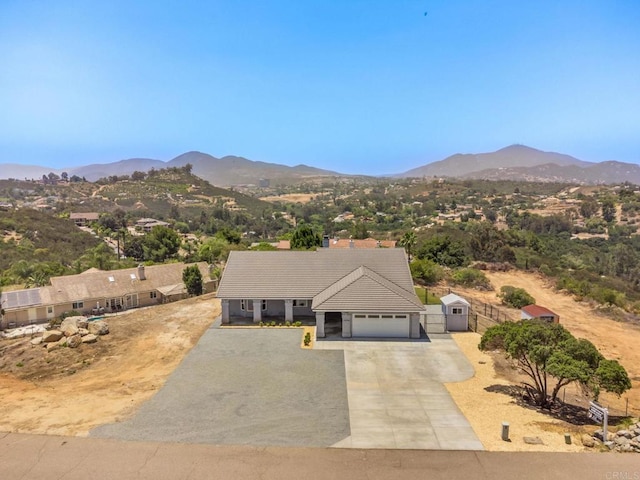 14694 Chaparral Slope Rd, Jamul, CA 91935 - view of front facade featuring a mountain view, a tiled roof, concrete driveway, a gate, and an attached garage
