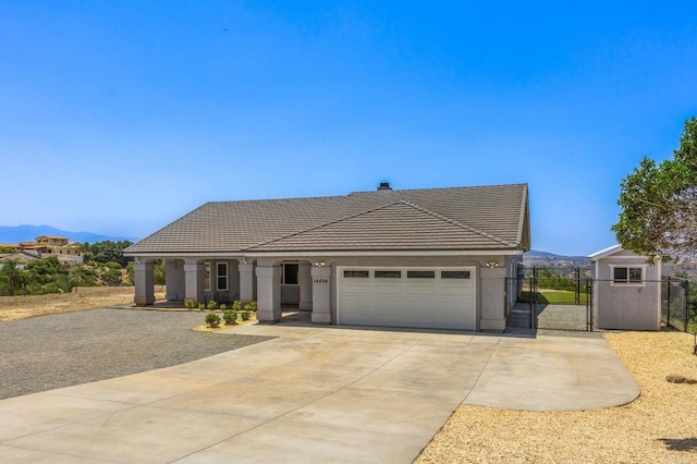 14694 Chaparral Slope Rd, Jamul, CA 91935 - view of front facade with a tiled roof, a gate, a mountain view, a garage, and driveway