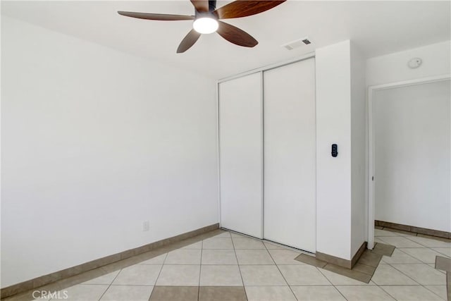 24409 Dunlavy Ct, Moreno Valley, CA 92557 - unfurnished bedroom featuring a closet, light tile patterned flooring, and ceiling fan