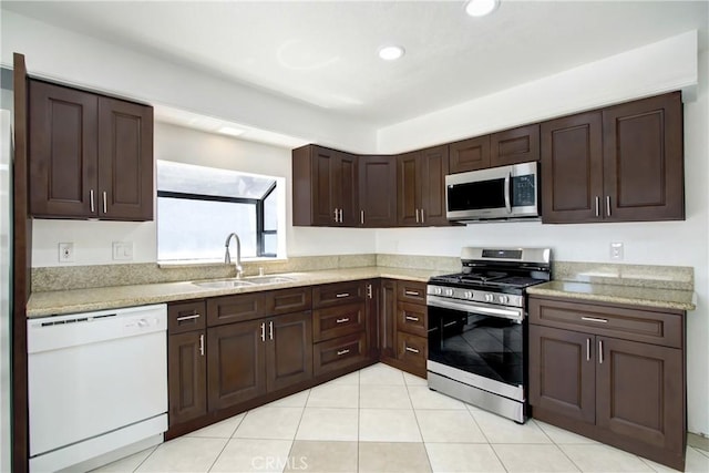 24409 Dunlavy Ct, Moreno Valley, CA 92557 - kitchen featuring appliances with stainless steel finishes, dark brown cabinets, recessed lighting, and light tile patterned flooring