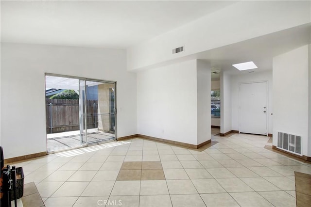 24409 Dunlavy Ct, Moreno Valley, CA 92557 - unfurnished room featuring healthy amount of natural light, a skylight, and light tile patterned flooring